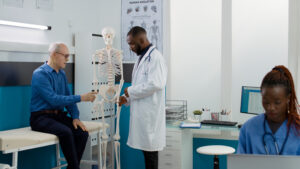 Calcium and Bone Medicine health specialist analyzing human skeleton bones in cabinet